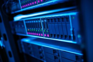 A close-up shot of a modern network server rack with glowing indicator lights in a secure data center.