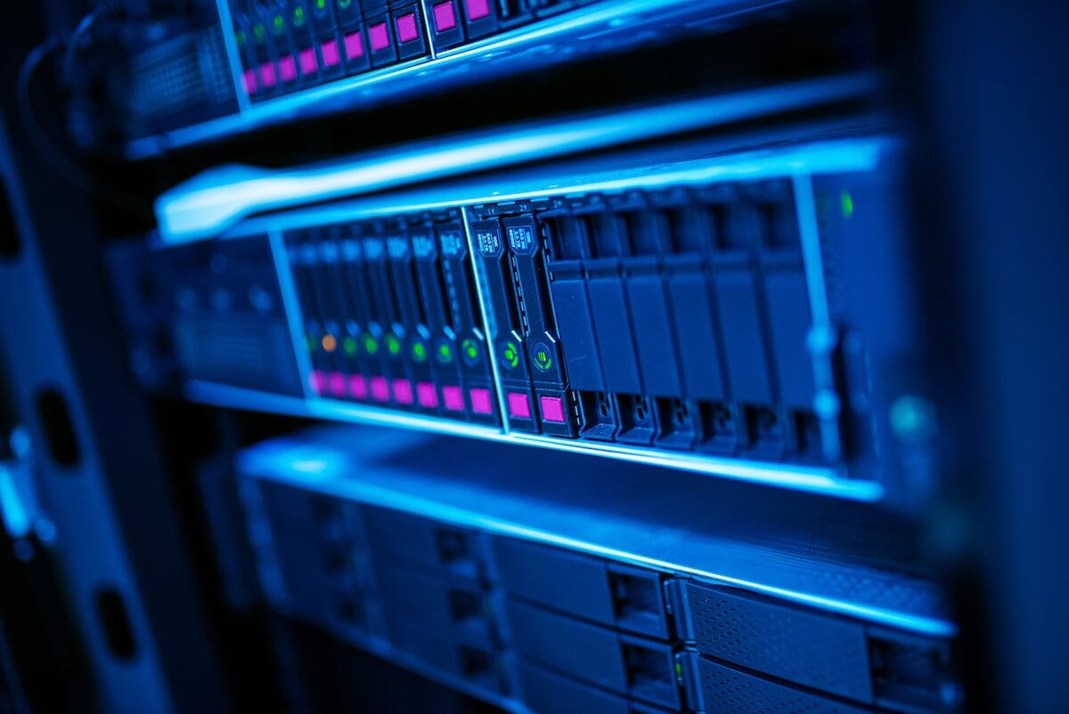 server rack A close-up shot of a modern network server rack with glowing indicator lights in a secure data center.