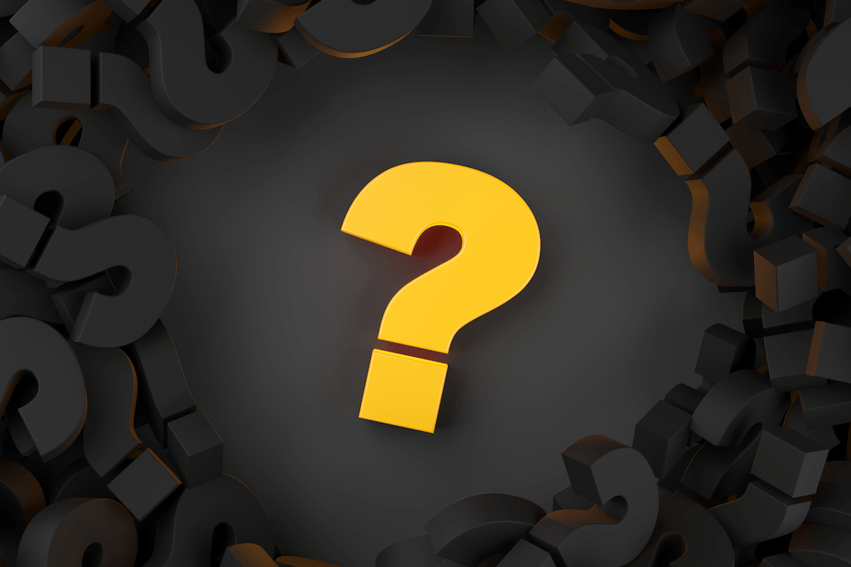 IT Provider Questions A bright yellow question mark centered amidst a pile of dark black question marks.