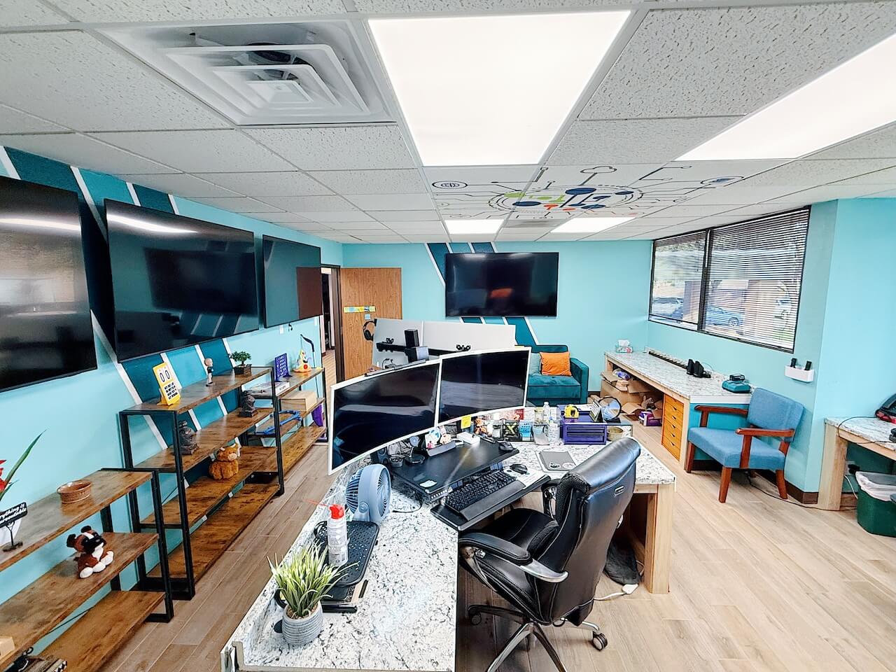 Photo of brightly West Texas IT Consulting Computer Lab work area with desks, computers, chairs, and monitors
