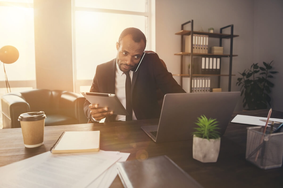 non-profit-it-security-compliance-review Professional reviewing reports and documentation at a desk with a laptop
