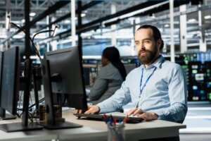 IT professional monitoring computer systems for cybersecurity threats