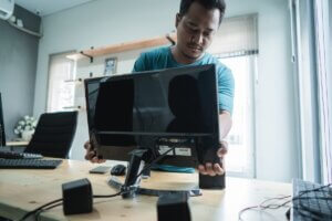 IT technician setting up a computer workstation for a supply company